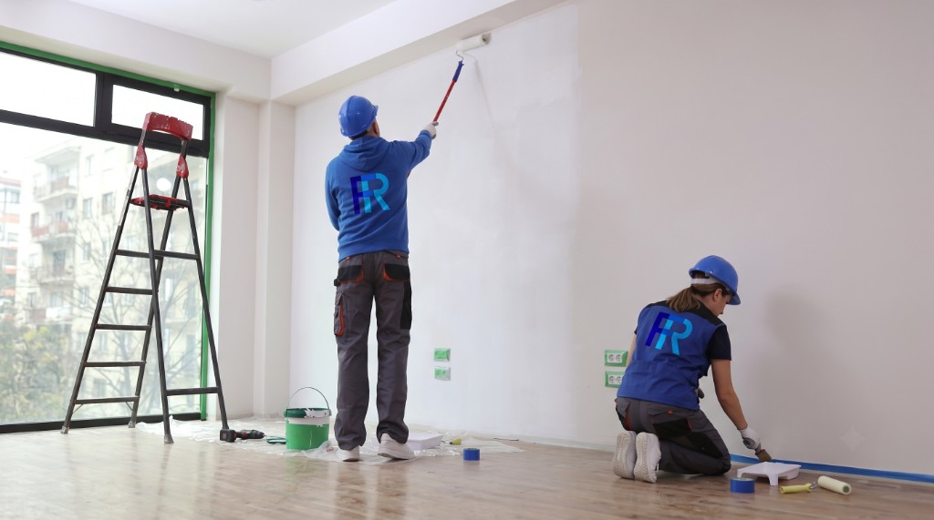 Focus Refurbishment painters decorating a bright interior — roller and detail brush work in progress
